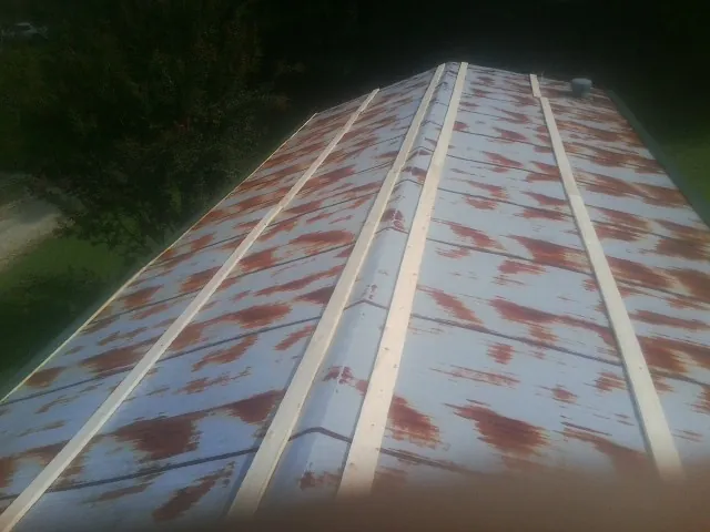 Rusted metal roof panels with new wood purlins before replacement — Storm Damage Roof Repair in Ellijay by Roofing Brothers